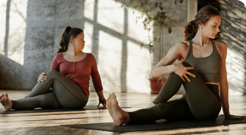 two woman doing a stretching session